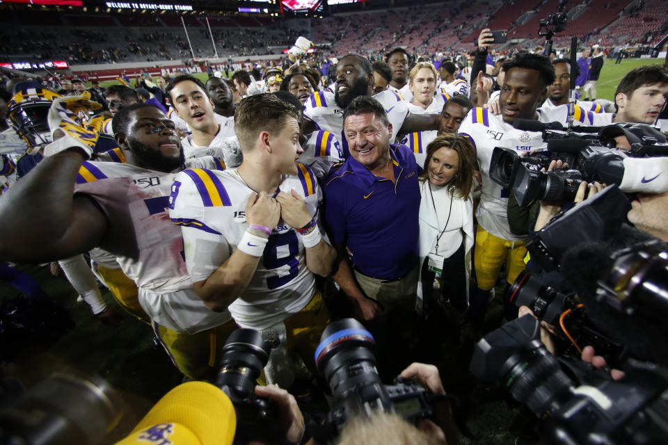 LSU head coach Ed Orgeron smiles at quarterback Joe Burrow after defeating Alabama in an NCAA football game Sunday, Nov. 10, 2019, in Tuscaloosa , Ala. LSU won 46-41. (AP Photo/John Bazemore)