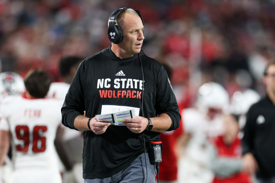 Dec 28, 2023; Orlando, FL, USA; North Carolina State Wolfpack head coach Dave Doeren looks on from the sidelines during the Pop-Tarts bowl against Kansas State Wildcats in the fourth quarter at Camping World Stadium. Mandatory Credit: Nathan Ray Seebeck-USA TODAY Sports