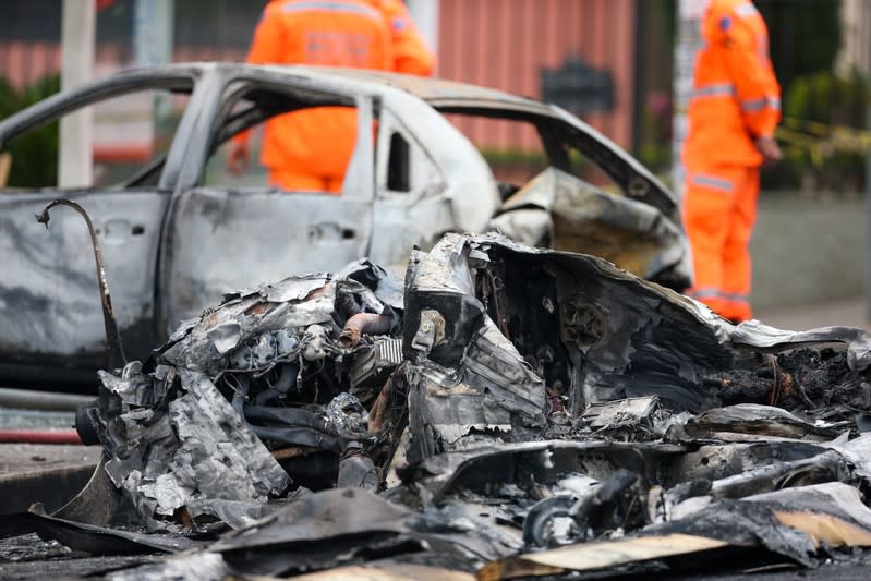 Wrecked cars are seen at the site where a small plane crashed on a residential street in Belo Horizonte