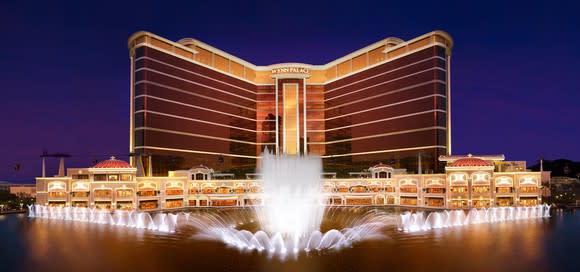 Wynn Palace resort in Macau, with view of front fountains at night.