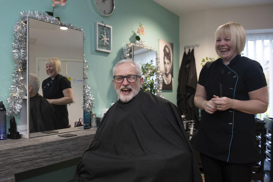 Britain's main opposition Labour Party leader Jeremy Corbyn reacts with hairdresser Charlotte Wilkins, at Windwood Heights Retirement Village while on the General Election campaign trail in Nottingham, England, Wednesday Dec. 4, 2019. The UK goes to the polls in a General Election on Dec. 12. (Joe Giddens/PA via AP)