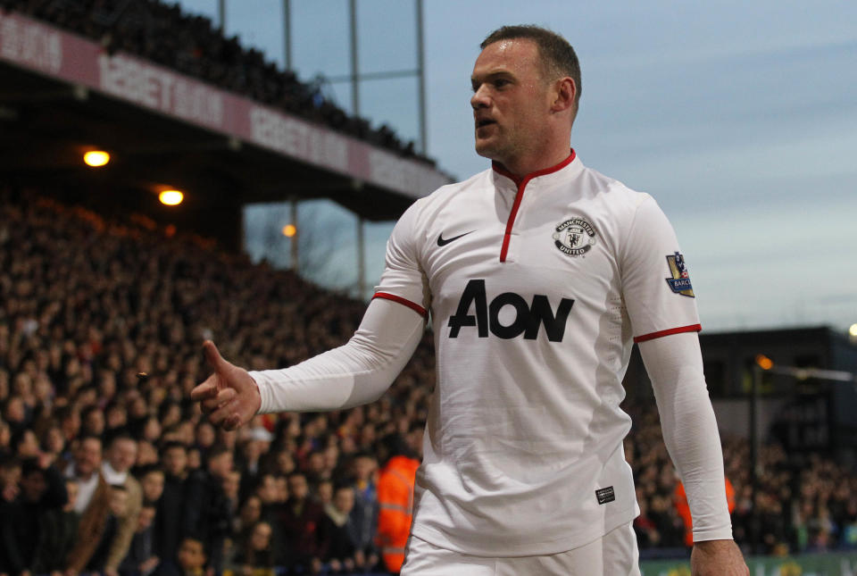 Manchester United's Wayne Rooney flips back a coin throw at him by Crystal Palace's supporters in a corner kick during their English Premier League soccer match at Selhurst Park, London, Saturday, Feb. 22, 2014. (AP Photo/Sang Tan)