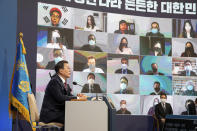 South Korean President Moon Jae-in speaks during an on-line New Year press conference with local and foreign journalists at the Presidential Blue House in Seoul, South Korea Monday, Jan. 18, 2021. (Jeon Heon-kyun/Pool Photo via AP)