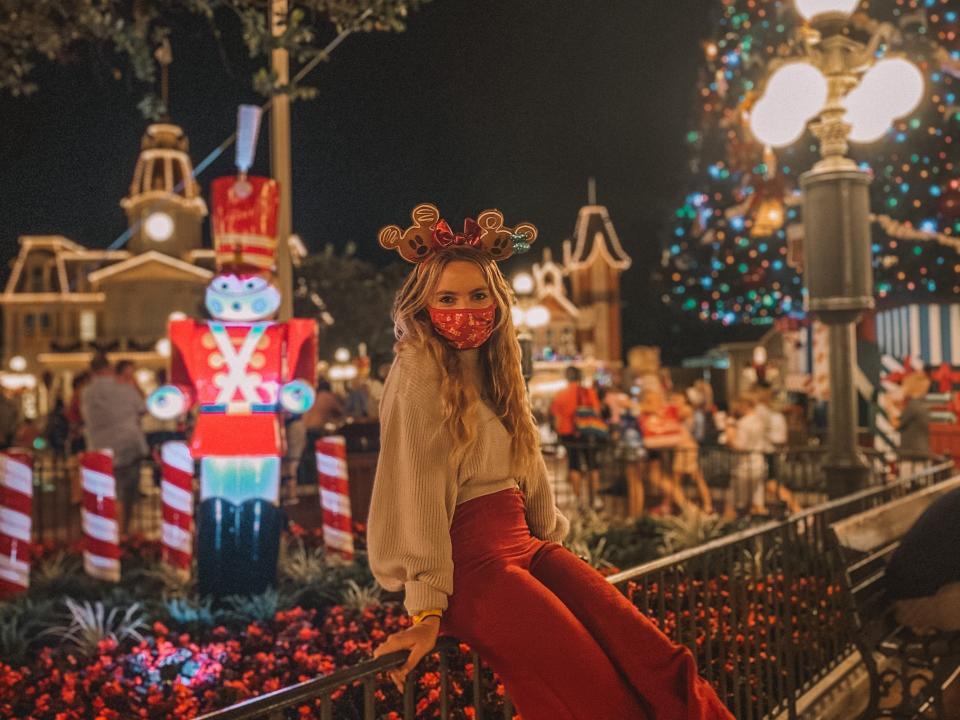 kayleigh sitting in front of the main street usa decorations at magic kingdom disney world