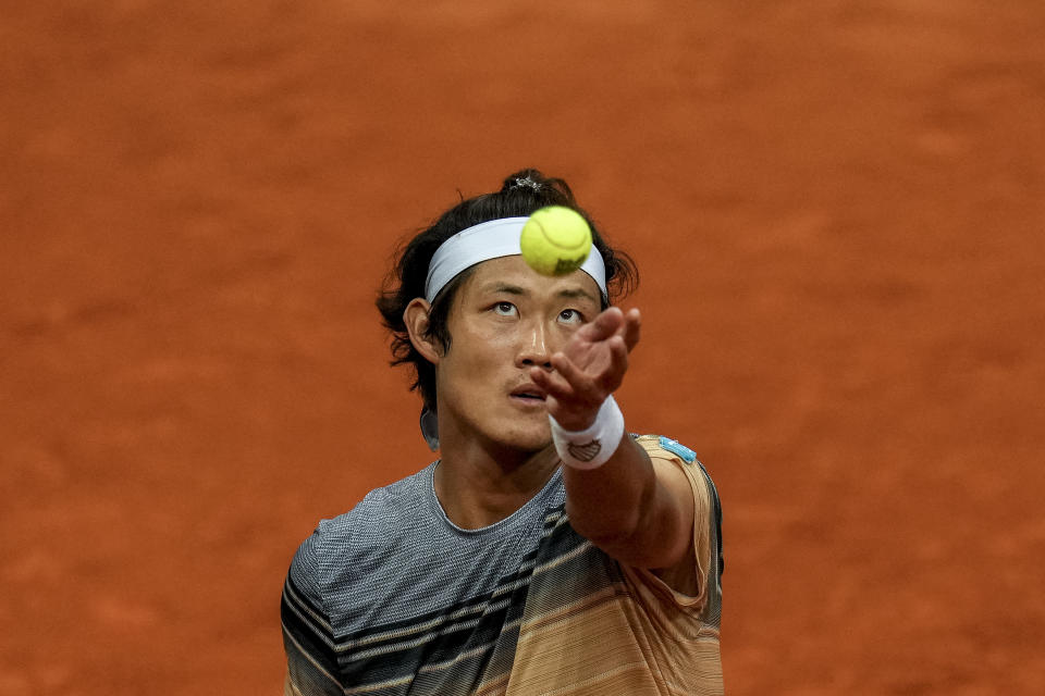 Zhang Zhizhen of China serves to Taylor Fritz, of the United States, during their match at the Madrid Open tennis tournament in Madrid, Spain, Tuesday, May 2, 2023. (AP Photo/Manu Fernandez)