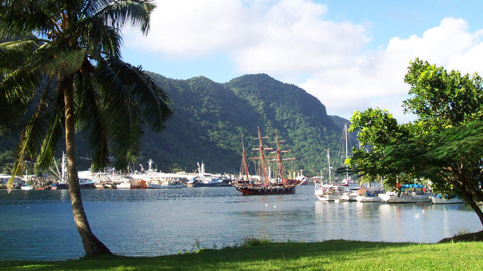 FILE - This July 2002 file photo shows a sailing ship in the harbor at Pago Pago, American Samoa. Many residents of American Samoa are concerned that a federal judge's recent ruling in Utah, saying those born in the U.S. territory should be recognized as U.S. citizens, could threaten "fa'a Samoa," the Samoan way of life, which includes cultural traditions like prayer curfews, communal living and a belief that the islands' lands should stay in Samoan hands. (AP Photo/David Briscoe, File)