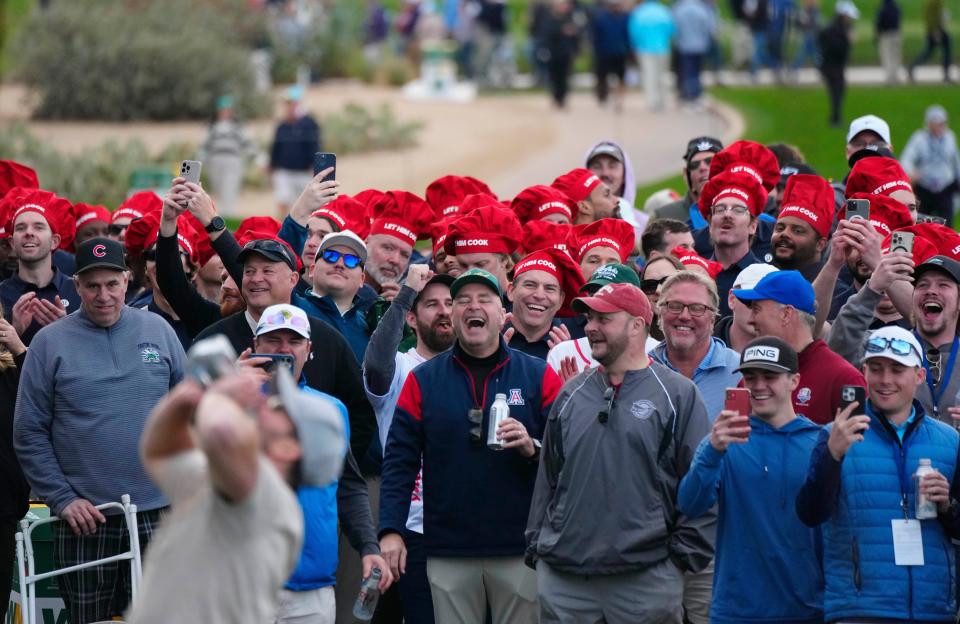 A fan pounds two beers together and chugs them before getting arrested near the 17th hole during the second round at the WM Phoenix Open at TPC Scottsdale on Feb. 9, 2024.