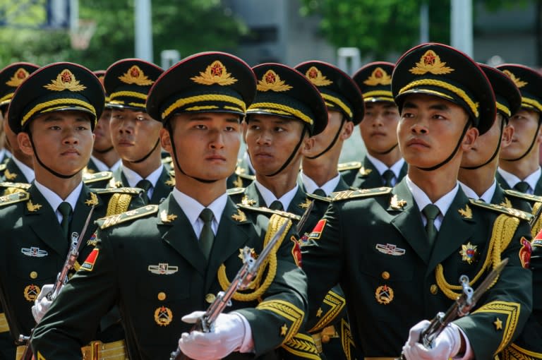 PLA soldiers march during the open day of the Chinese People's Liberation Army (PLA) Navy Base at Stonecutter Island in Hong Kong on July 1, 2016, to mark the 19th anniversary of the Hong Kong handover to China