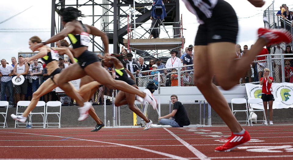 Jessica Zelinka, far left, from London, Ont., crosses the finish line to win the women's 100-metre hurdles at the Canadian Track and Field Championships in Calgary, Alta., Saturday, June 30, 2012.THE CANADIAN PRESS/Jeff McIntosh