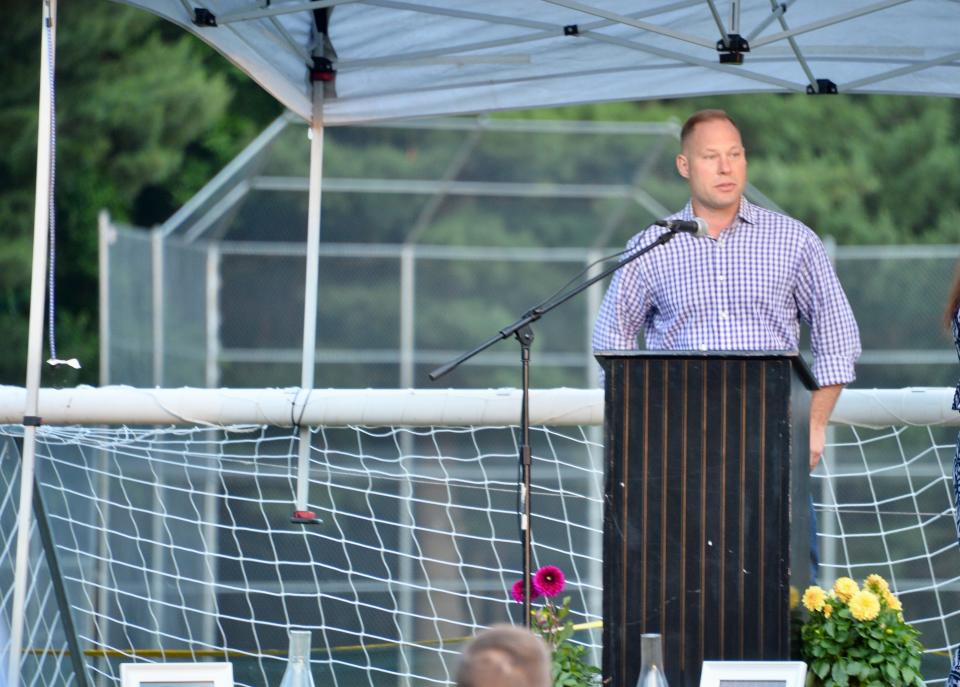 Patrick Grach, lead pastor at Lifehouse Church in Hagerstown, addresses more than 100 people Saturday night during a vigil at Lions Community Park for the victims of the June 9 shooting at nearby Columbia Machine.