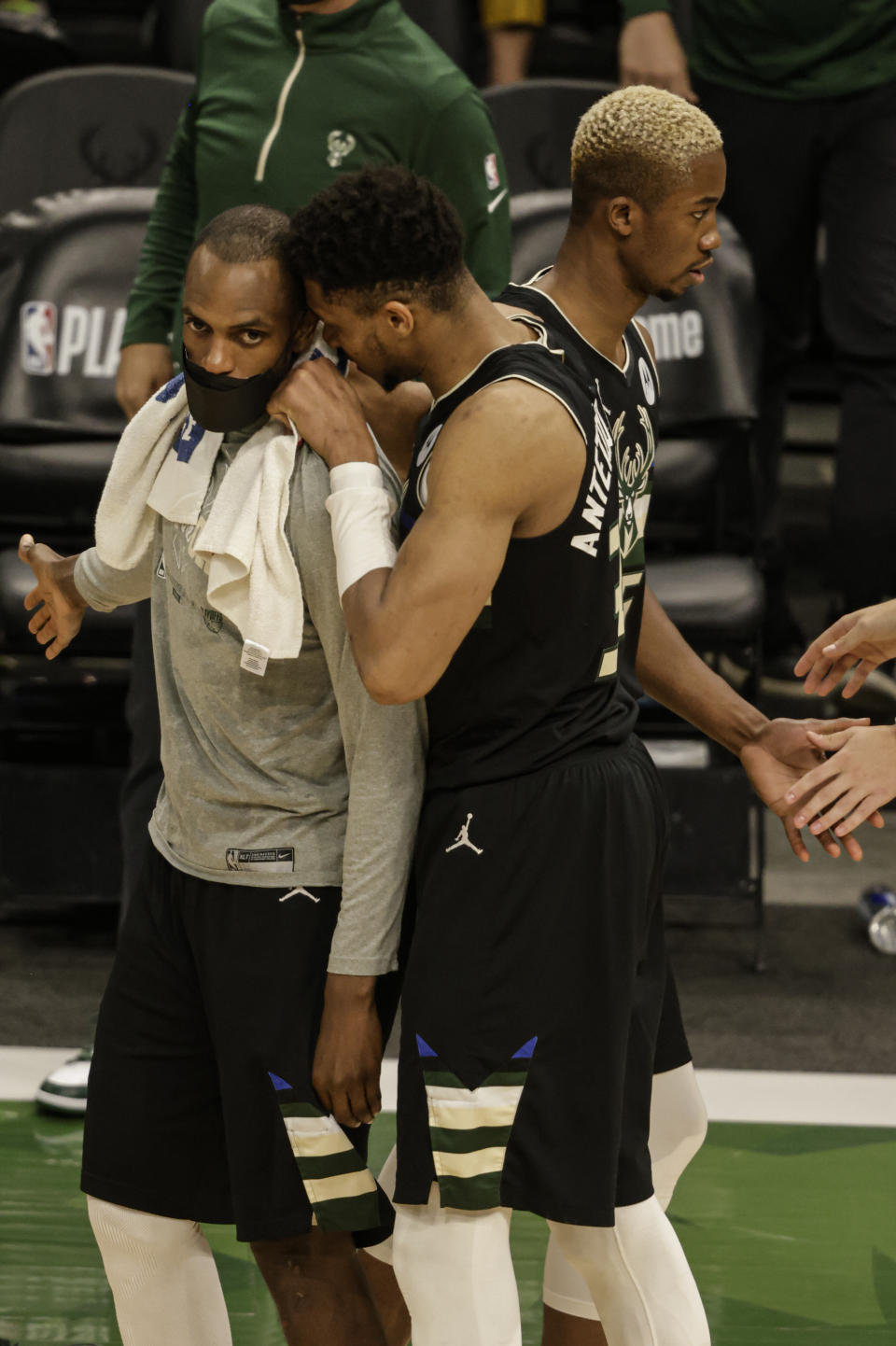 Milwaukee Bucks forward Giannis Antetokounmpo, front right, speaks to Khris Middleton at the end of Game 6 of a second-round NBA basketball playoff series against the Brooklyn Nets, Thursday, June 17, 2021, in Milwaukee. (AP Photo/Jeffrey Phelps)