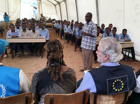 Christos Stylianides (R), European Union Commissioner for Humanitarian Aid and Crisis Management, meets with students at the Dadaab refugee camp in Kenya January 21, 2016. REUTERS/Edmund Blair