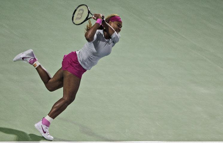 Serena Williams of the U.S. returns the ball to Ekaterina Makarova of Russia during the second round of Dubai Duty Free Tennis Championships in Dubai, United Arab Emirates, Tuesday, Feb. 18, 2014. (AP Photo/Kamran Jebreili)