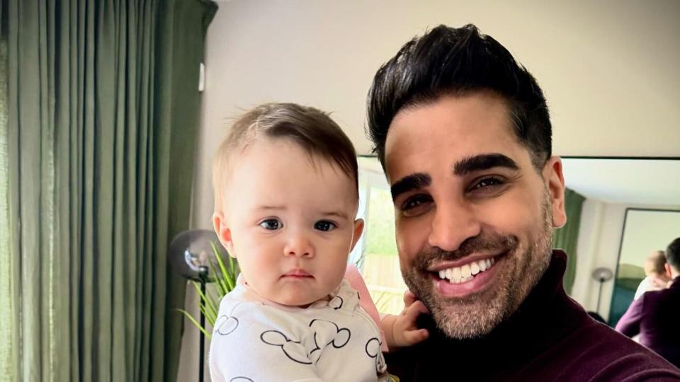 dr ranj smiling holding lyra