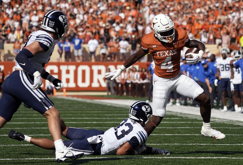 Texas running back CJ Baxter (4) tries to side step BYU safety Raider Damuni (33) during the first half of an NCAA college football game in Austin, Texas, Saturday, Oct. 28, 2023. | Eric Gay, Associated Press