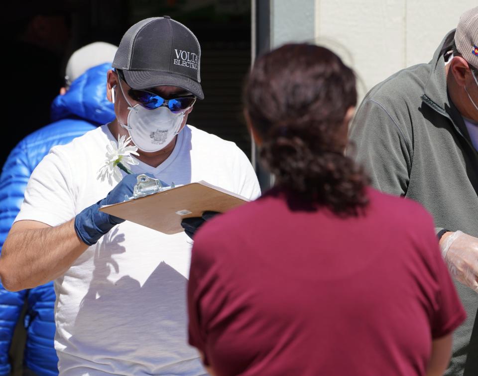 Volunteer Arturo Zuniga, 43, helps a customer at the Avon, Colorado, Salvation Army food bank on March 26, 2020, during the coronavirus outbreak.