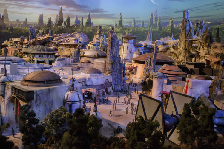 <p>A full-sized TIE dominates the far side of <em>Galaxy’s Edge</em>. We also know that there are two giant AT-ATs being built, but they weren’t visible on the model… presumably they’re hidden somewhere, possibly in the middle section. (Disney Parks/Joshua Sudock) </p>