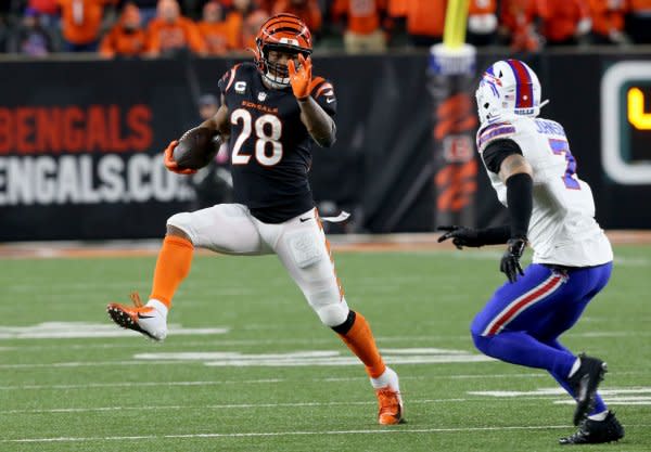 Cincinnati Bengals running back Joe Mixon (L) breaks free from Buffalo Bills defender Taron Johnson on Sunday at Paycor Stadium in Cincinnati. Photo by John Sommers II/UPI