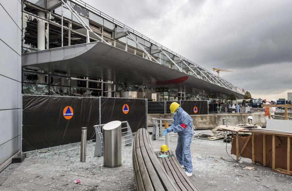 FILE - A forensics officer works in front of the damaged Zaventem Airport terminal in Brussels, March 23, 2016 . A jury is expected to render its verdict Tuesday, July 25, 2023 over Belgium’s deadliest peacetime attack. The suicide bombings at the Brussels airport and a busy subway station in 2016 killed 32 people in a wave of attacks in Europe claimed by the Islamic State group. Among the 10 defendants is Salah Abdeslam, serving a life sentence in France over his role in 2015 Paris attacks. (AP Photo/Geert Vanden Wijngaert, Pool, FIle)
