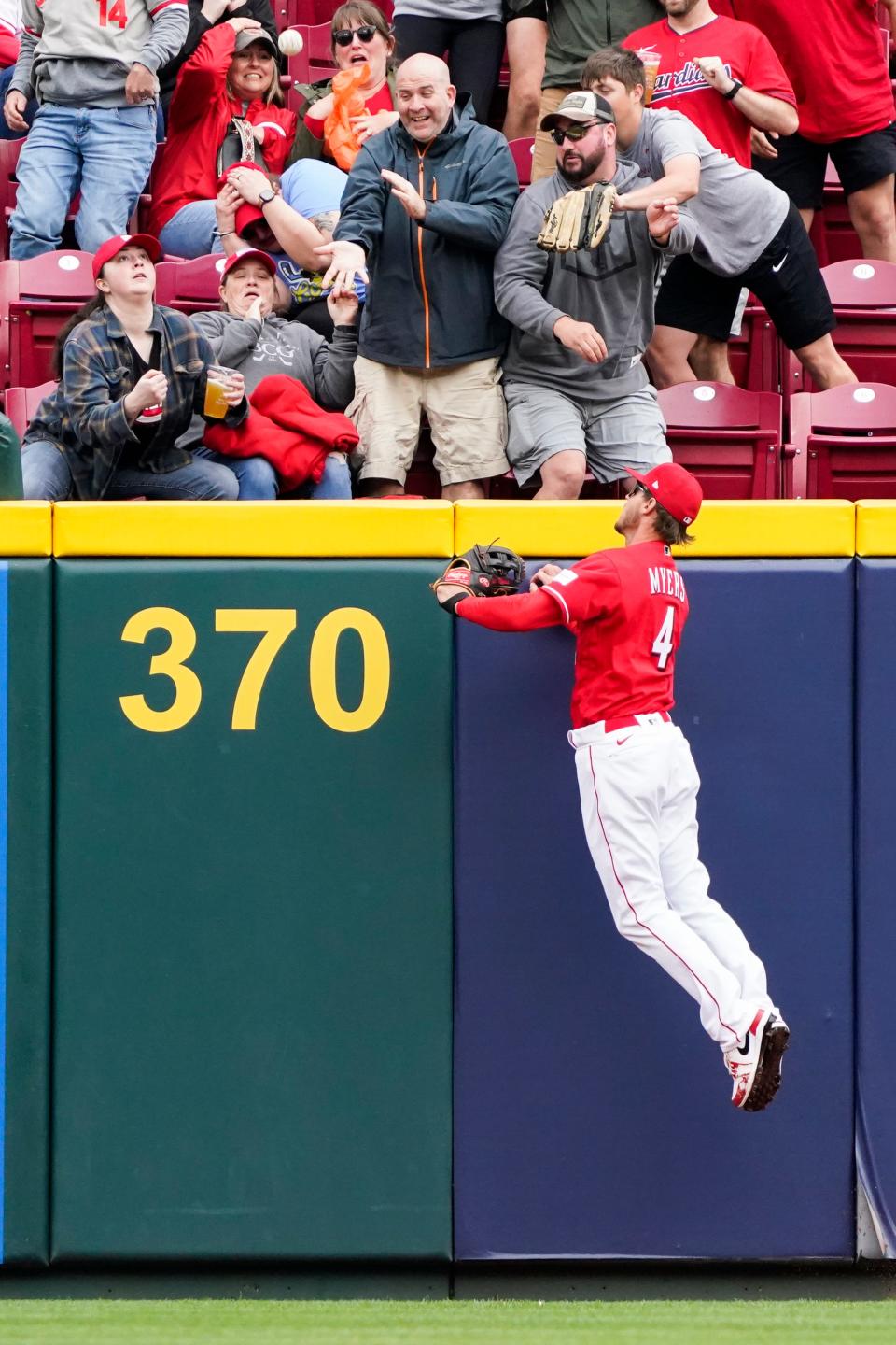 Cincinnati Reds right fielder Wil Myers (4) watches as a solo home run by Philadelphia Phillies' Bryson Stott falls into the stands during the first inning of a baseball game, Sunday, April 16, 2023, in Cincinnati.