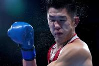 <p>Kazakhstan's Bekzad Nurdauletov (red) and Russia's Imam Khataev fight during their men's light heavy (75-81kg) preliminaries round of 16 boxing match during the Tokyo 2020 Olympic Games at the Kokugikan Arena in Tokyo on July 28, 2021. (Photo by Frank Franklin II / POOL / AFP)</p> 