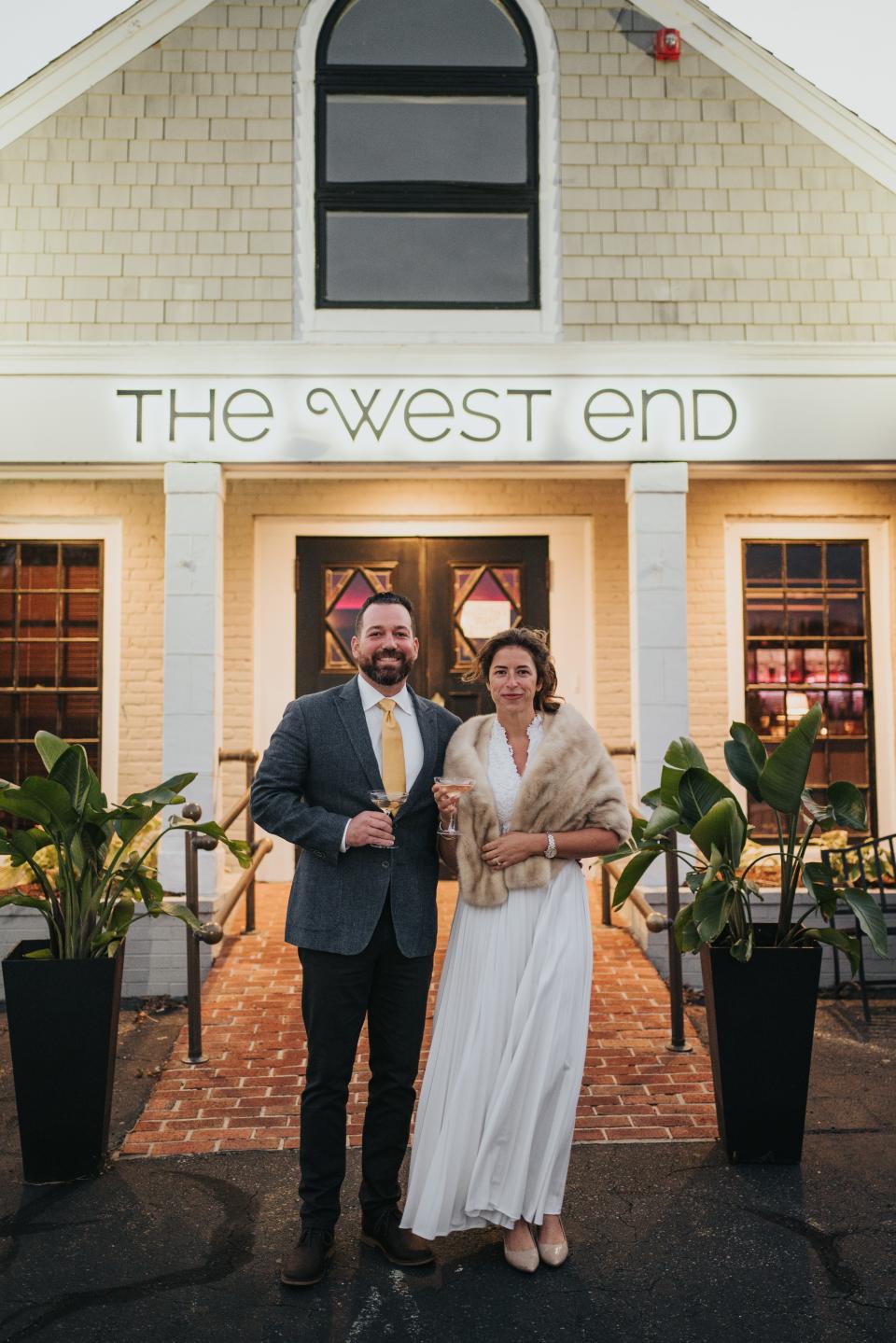 Blane Toedt and Jen Villa, dressed in vintage garb outside their century-old restaurant where they held their wedding rehearsal dinner in 2020.