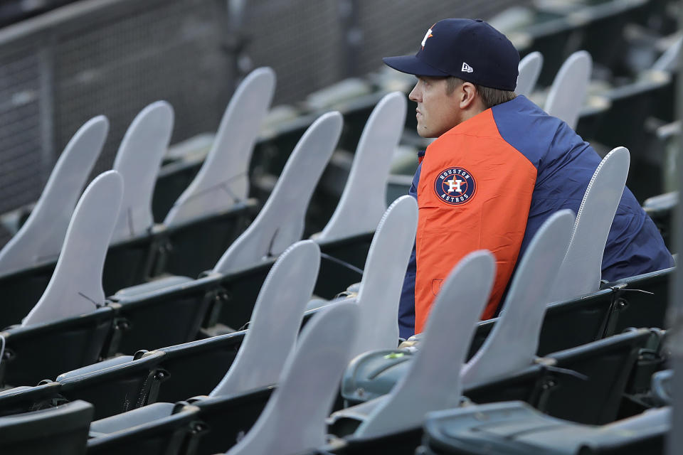 Houston Astros pitcher Zack Greinke socially distances himself beside cardboard cutout fans in the stands of the Oakland Coliseum in the fourth inning of a baseball game against the Oakland Athletics on Friday, Aug. 7, 2020, in Oakland, Calif. (AP Photo/Ben Margot)