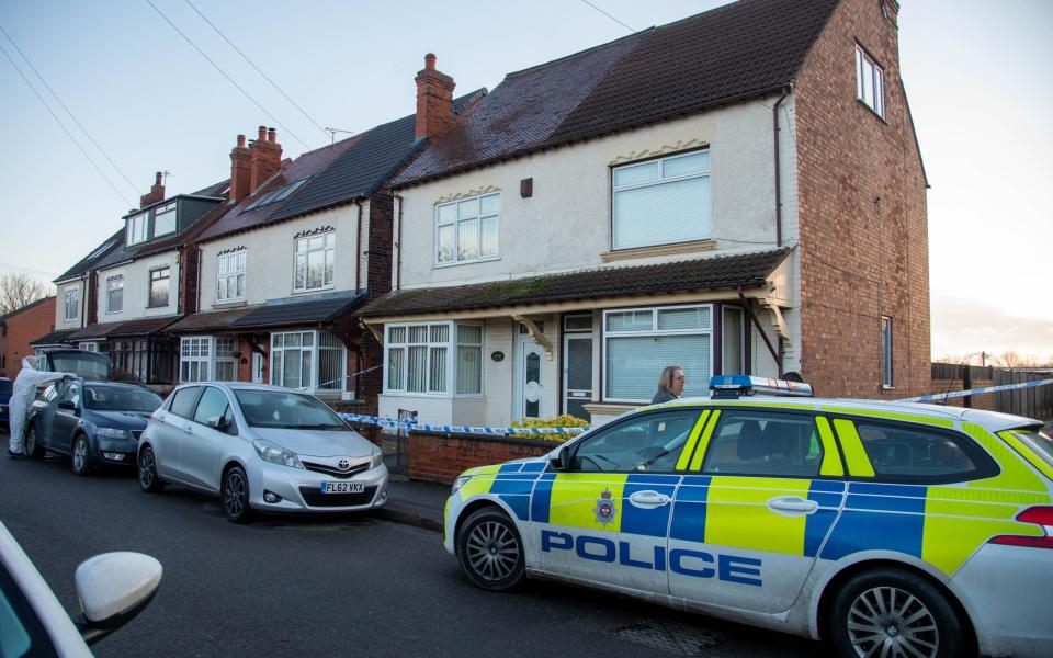 A police car and cordon outside the couple's home