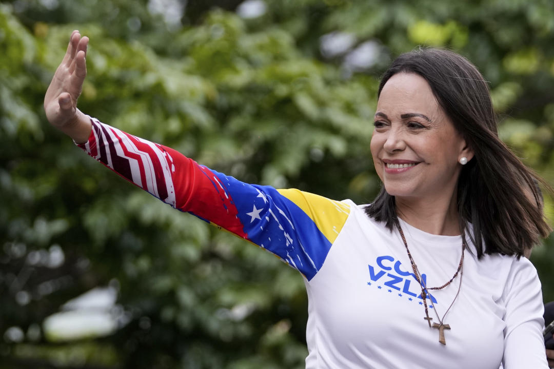 Opposition leader Maria Corina Machado waves from atop a truck during the closing election campaign rally for presidential candidate Edmundo Gonzalez in Caracas, Venezuela, Thursday, July 25, 2024. The presidential election is set for July 28. (AP Photo/Matias Delacroix)