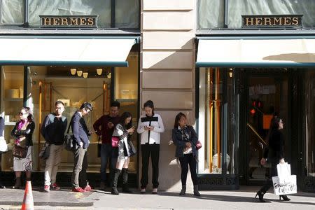 Customers queue up as they wait the opening of the main shop of French luxury group Hermes in Paris, France, in this picture taken on September 23, 2015. Picture taken September 23, 2015. REUTERS/Charles Platiau/Files