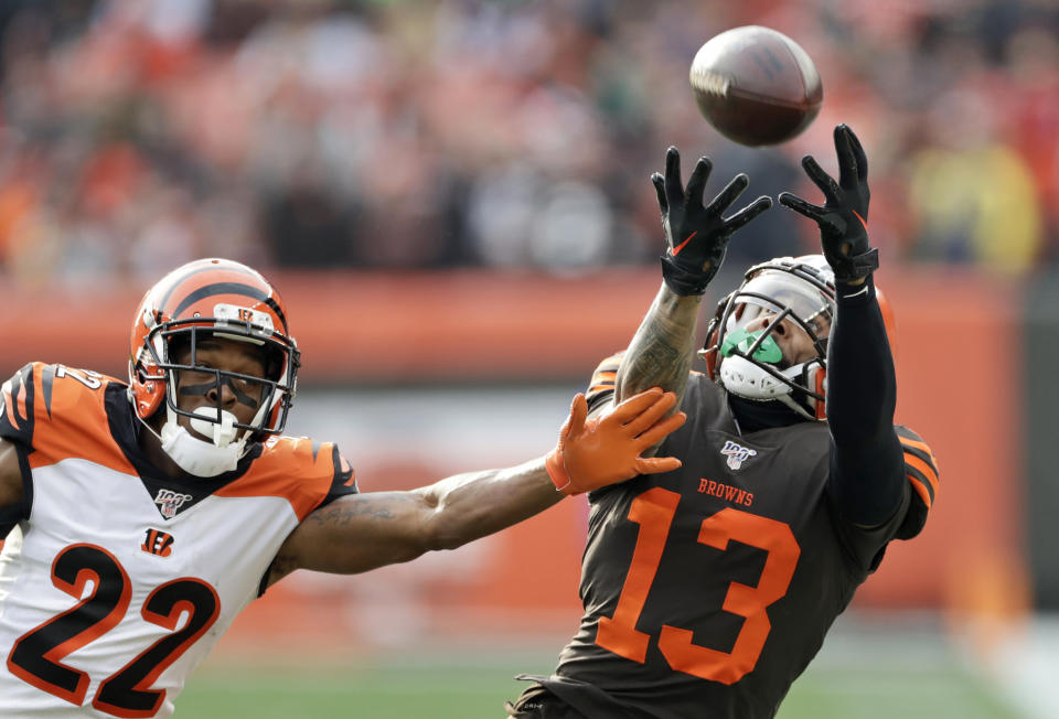 Cleveland Browns wide receiver Odell Beckham Jr. (13) can't hold onto the ball under pressure from Cincinnati Bengals cornerback William Jackson (22) during the first half of an NFL football game, Sunday, Dec. 8, 2019, in Cleveland. (AP Photo/Ron Schwane)