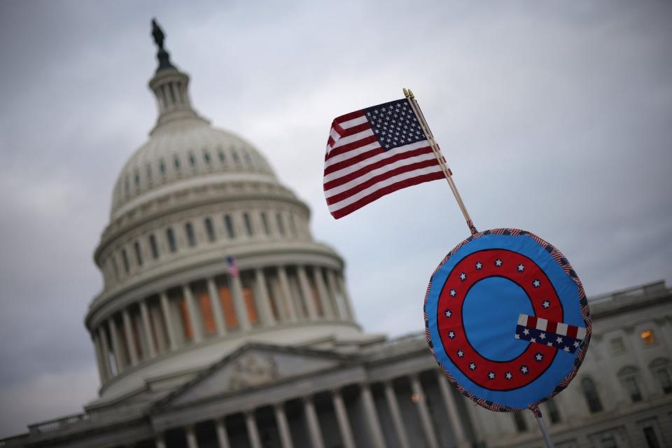 <span class="caption">Many of those arrested in the U.S. Capitol siege on Jan. 6, 2021, were QAnon believers.</span> <span class="attribution"><a class="link " href="https://www.gettyimages.com/detail/news-photo/supporters-of-u-s-president-donald-trump-fly-a-u-s-flag-news-photo/1294904312?adppopup=true" rel="nofollow noopener" target="_blank" data-ylk="slk:Win McNamee/Getty Images;elm:context_link;itc:0;sec:content-canvas">Win McNamee/Getty Images</a></span>