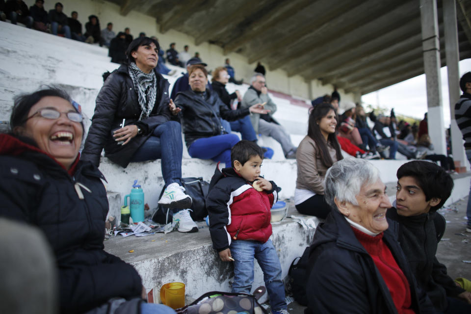 Fans of the soccer team "Papa Francisco," or Pope Francis, watch their team's debut game against Trefules in Lujan, Argentina, Saturday, April 12, 2014. The new semi-professional team named their team in honor of the Argentine pontiff. (AP Photo/Victor R. Caivano)