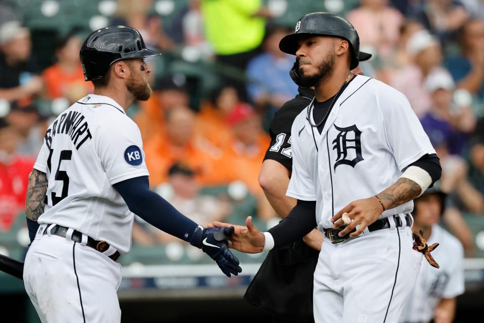 Tigers first baseman Harold Castro (right) receives congratulations from catcher Tucker Barnhart after scoring in the third inning against the Angels Aug. 20, 2022 in Detroit.