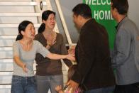 <p>Journalist Euna Lee (left) embraces her husband Michael Saldate (far right) and daughter Hana, while fellow journalist Laura Ling (second from left) greets husband Iain Clayton after being released from North Korea. Following talks in Pyongyang with former U.S. president Bill Clinton, North Korean leader Kim Jong Il pardoned Lee and Ling, who had been sentenced to hard labor for entering the country illegally. </p>