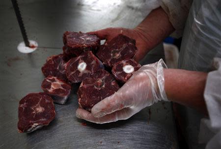 Butcher Trevor Hart cuts up kangaroo meat at a meat packing and distribution warehouse in western Sydney November 6, 2013. REUTERS/David Gray