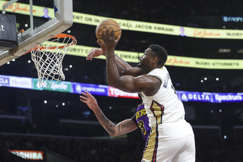 New Orleans Pelicans forward Zion Williamson (1) shoots Los Angeles Lakers forward-center Anthony Davis (3) defends during the first half of an NBA basketball game Friday, Feb. 9, 2024, in Los Angeles. (AP Photo/Yannick Peterhans)