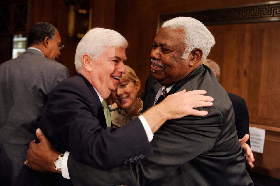 Former Senator Chris Dodd, D-Conn., left, hugs Bertie Bowman, a staffer with the Senate Foreign Relations Committee, before a subcommittee hearing in Dirksen Building entitled "The Peace Corps, The Next Fifty Years."