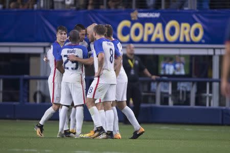 Jul 22, 2017; Arlington, TX, USA; United States forward Clint Dempsey (28) and midfielder Darlington Nagbe (25) and forward Jordan Morris (8) and midfielder Michael Bradley (26) celebrate a goal by Dempsey against Costa Rica during the second half at AT&T Stadium. The United States shut out Costa Rica 2-0. Mandatory Credit: Jerome Miron-USA TODAY Sports