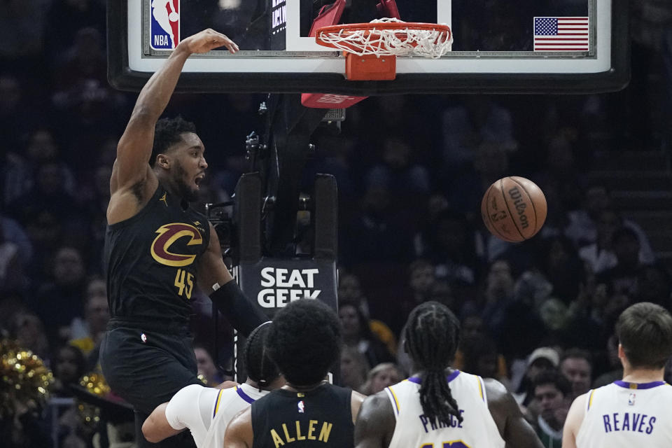 Cleveland Cavaliers guard Donovan Mitchell (45) dunks against the Los Angeles Lakers during the first half of an NBA basketball game Saturday, Nov. 25, 2023, in Cleveland. (AP Photo/Sue Ogrocki)