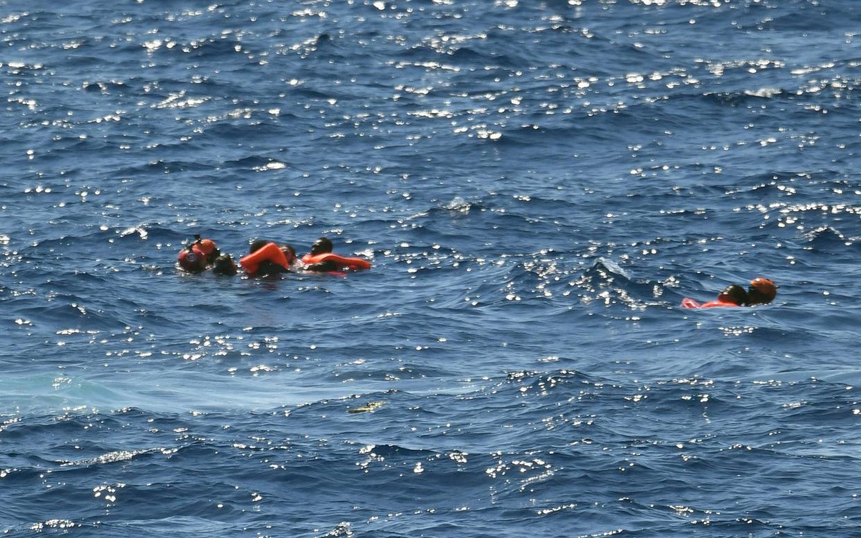 Migrants who jumped off the Spanish humanitarian rescue ship Open Arms are rescued after a desperate bid to reach the shore of the island of Lampedusa, southern Italy - AP