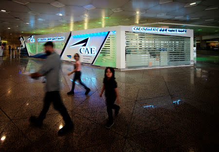 Travellers walk past the registration centre, CAE Oxford ATC, where Saudi women can pursue their carrier as a commercial pilots, at King Fahd International Airport in Dammam, Saudi Arabia, July 15, 2018. REUTERS/Hamad I Mohammed