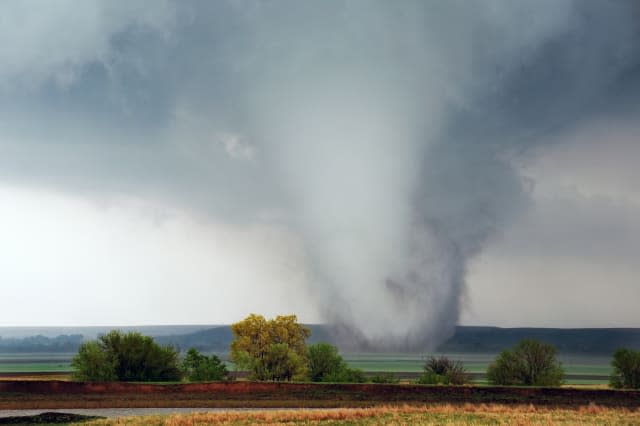 White cone tornado moves across Kansas field near Salina, Kansas April 14, 2012.