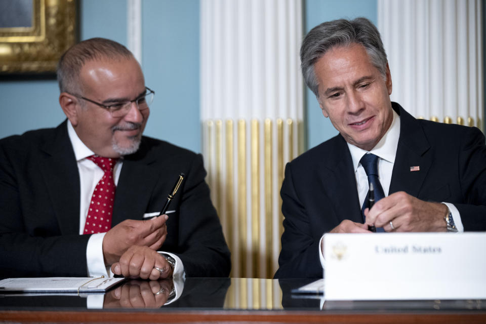 Bahraini Crown Prince Al Khalifa, left, offers his pen as Secretary of State Antony Blinken has trouble with his pen as he signs a Comprehensive Security Integration and Prosperity Agreement during a signing ceremony at the State Department, Wednesday, Sept. 13, 2023, in Washington. (AP Photo/Andrew Harnik)