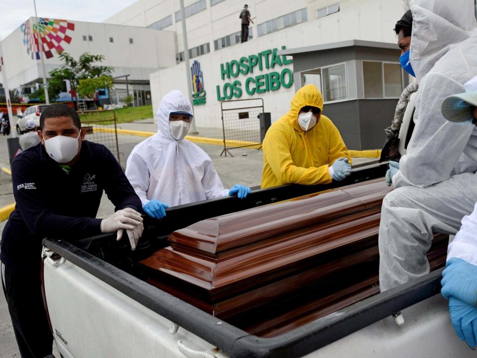 Funeral workers wait with a coffin in the back of a pick-up truck outside Los Ceibos hospital as health and funeral services have been overwhelmed amid the outbreak of the coronavirus disease (COVID-19), in Guayaquil: REUTERS