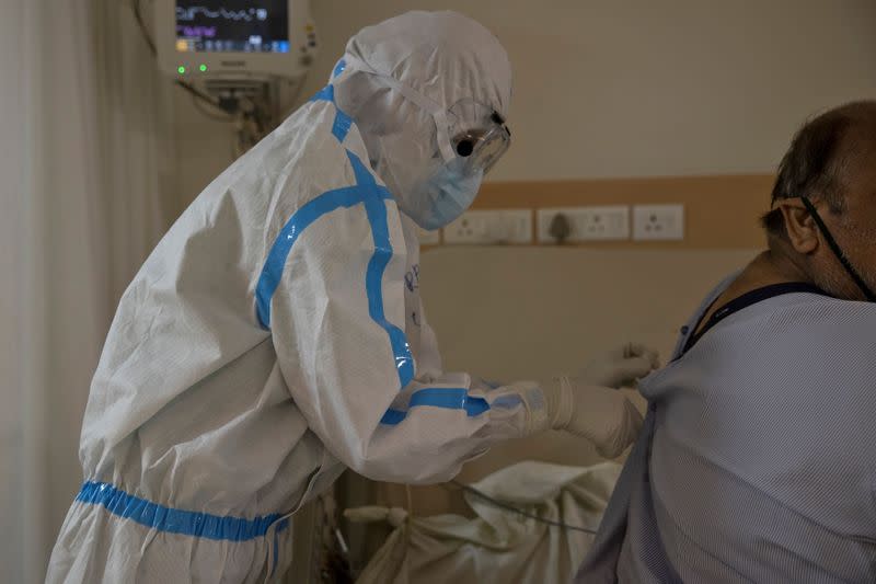 Medical workers treat patients infected with the coronavirus disease (COVID-19) at a hospital in New Delhi