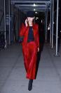 <p>In a shiny red, '90s-inspired suit, with black boots and a black hat, while out in New York.</p>