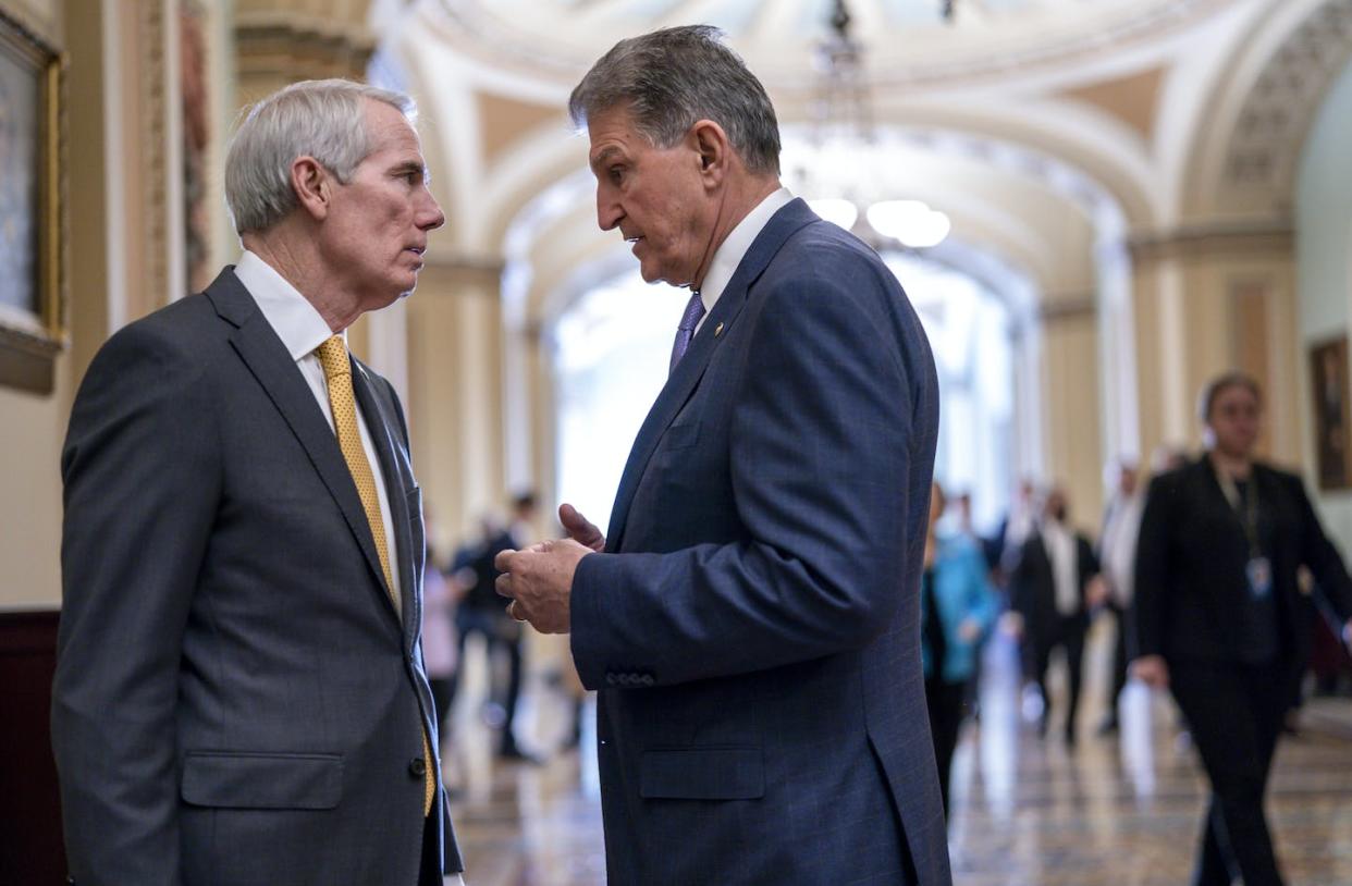 Sen. Rob Portman, R-Ohio, left, and Sen. Joe Manchin, D-W.Va., confer just off the Senate floor at the Capitol in Washington on March 29, 2022. Portman did not seek reelection for his seat. <a href="https://newsroom.ap.org/detail/CongressBidenBudget/6b8291cb065c46b7b07d0a1b0ca82bc5/photo?Query=bipartisan%20senate&mediaType=photo&sortBy=arrivaldatetime:desc&dateRange=Anytime&totalCount=1957&currentItemNo=77" rel="nofollow noopener" target="_blank" data-ylk="slk:AP Photo/J. Scott Applewhite;elm:context_link;itc:0;sec:content-canvas" class="link ">AP Photo/J. Scott Applewhite</a>