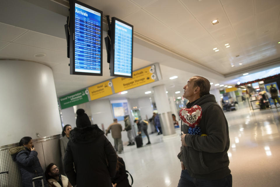 In this Dec. 3, 2019, photo, Mohammed Hafar checks the arrivals road while waiting for his daughter Jana Hafar's flight at JFK Airport in New York. Mohammed Hafar was part of a federal lawsuit filed in August of this year over the travel ban waiver process. “Every time I speak to her, she ask, ‘When are they going to give me the visa?'" the elder Hafar said, recalling the days of uncertainty that took up the better part of this year. There was “nothing I could tell her, because nobody knows when." (AP Photo/Mary Altaffer)