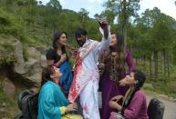 Pakistani actor Shahid Khan (C) stars in a scene with actresses during the shooting of Pashto film "Ma Chera Gharib Sara" (Don't Pester the Poor) in Murree